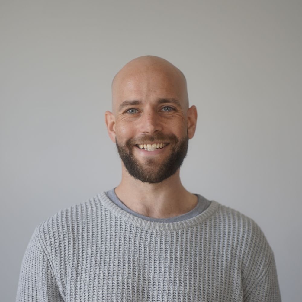 Dan, our Paid Marketing Lead, wearing gray sweater against a plain background.